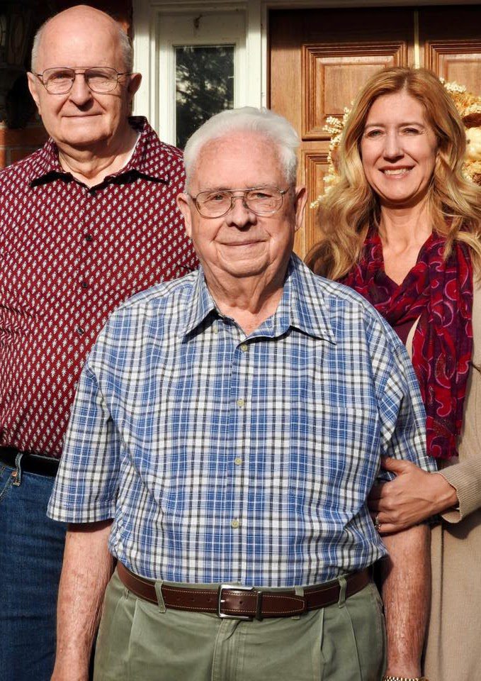 Three generations of the Turman family together outside a home